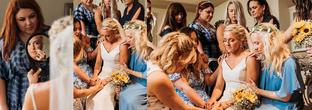 bridesmaids say a quick prayer with bride before beginning of ceremony 