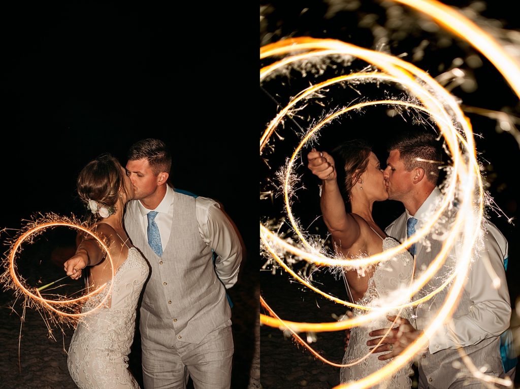 bride holds sparklers at mainsail resort with Destin wedding photographer