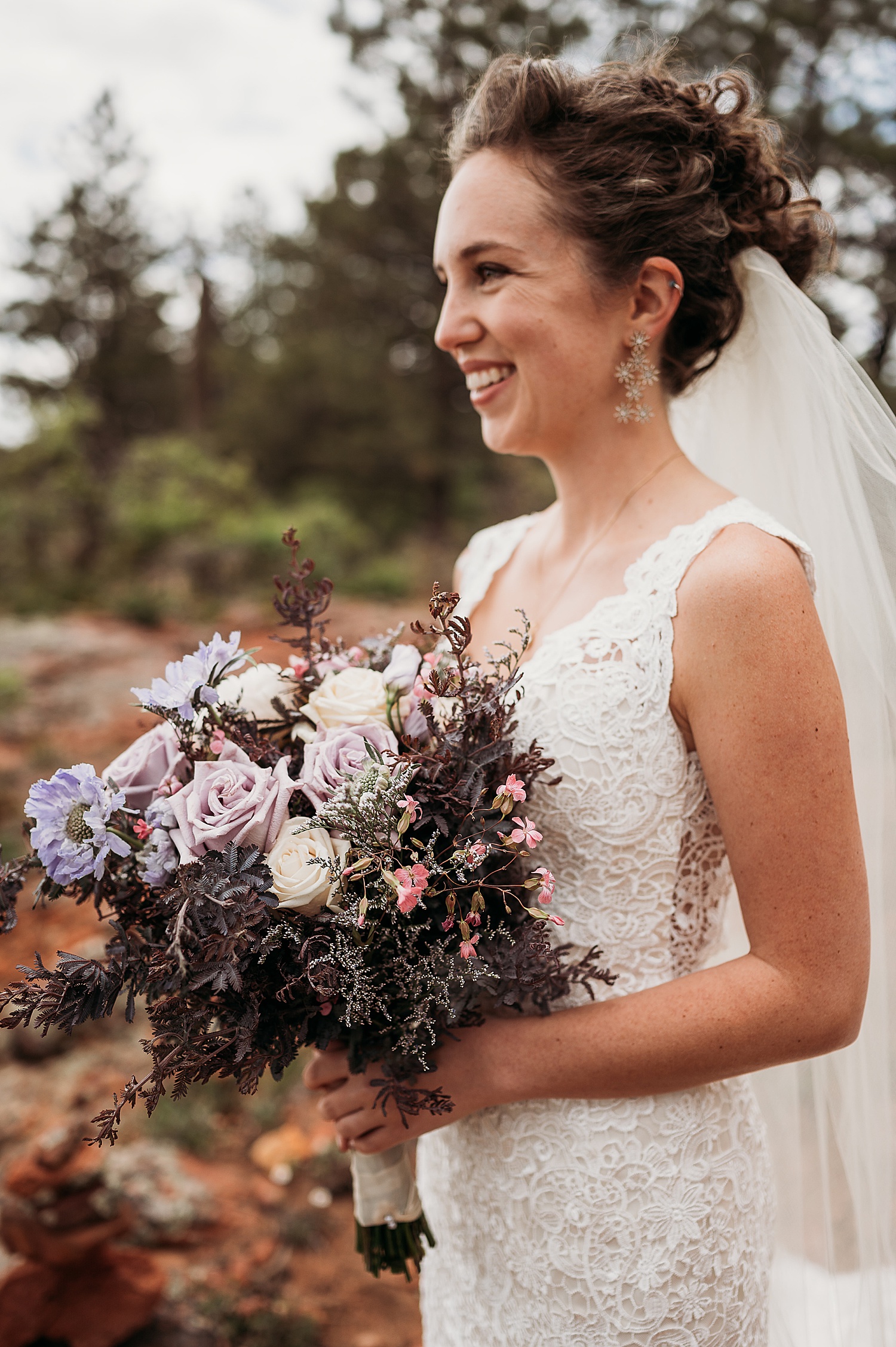 bride holding wedding bouquet on wedding day in Santa Fe National forest 