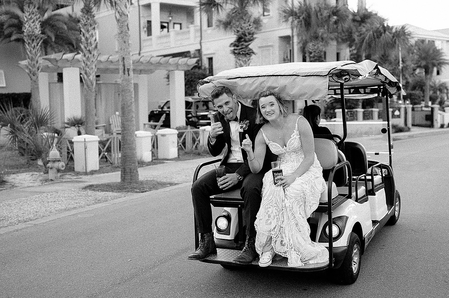Bride and groom take golf cart to wedding reception