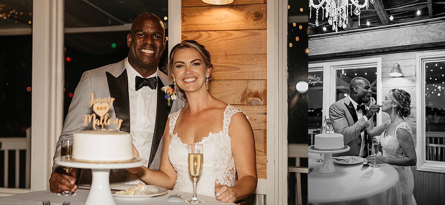 Bride and groom cut wedding cake while holding champagne flutes at wedding reception