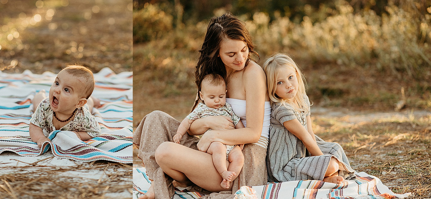 baby boy laying on mommas lap while back to back with daughter during beach family session 