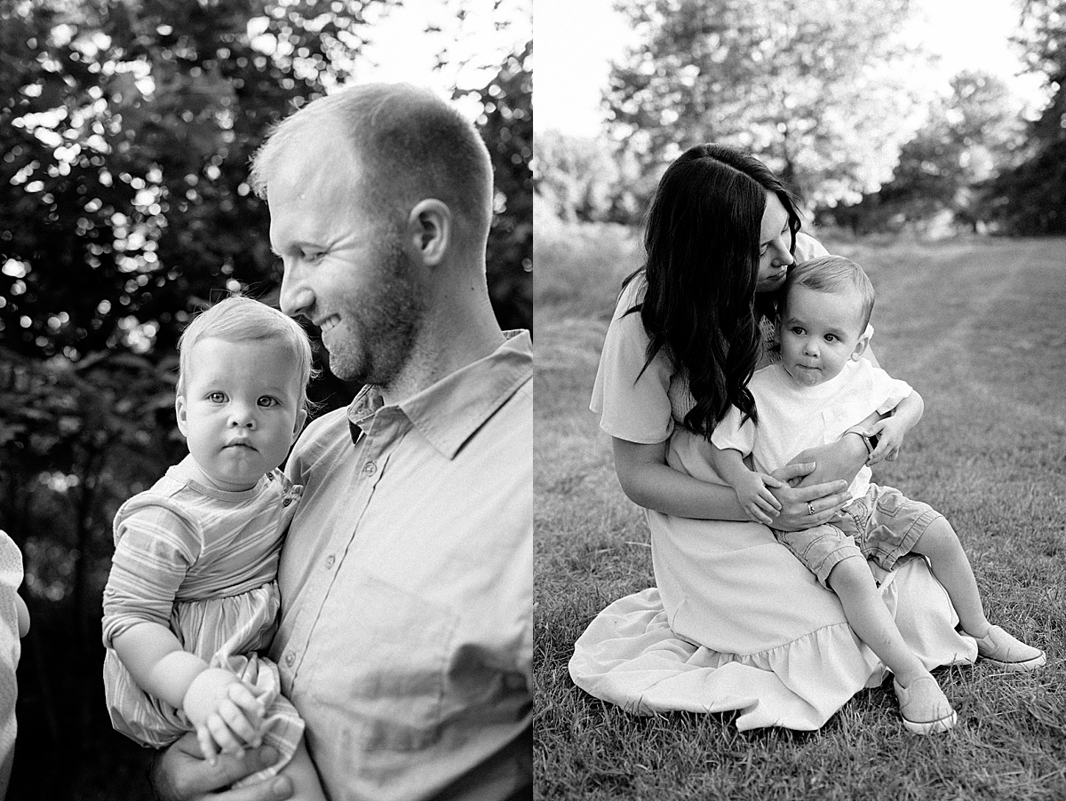 black and white photo of parents and kids sitting in the park by Emily burns photo
