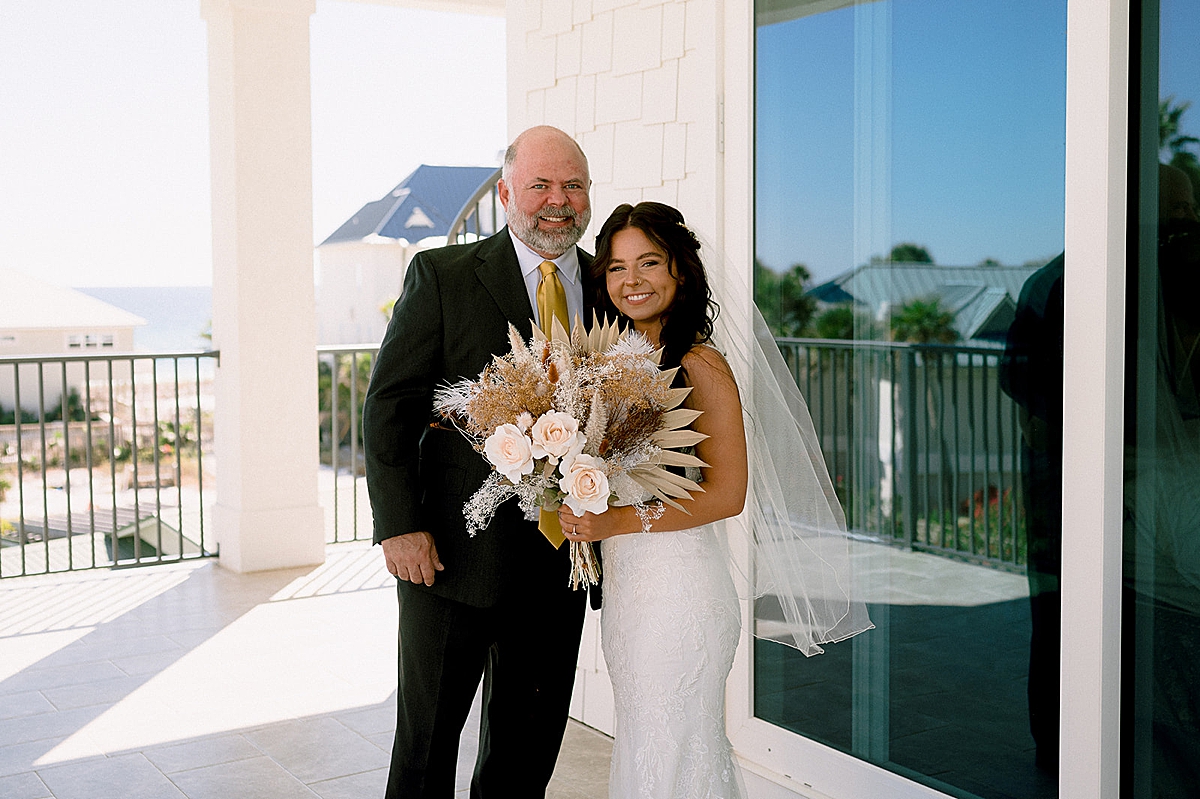 father of bride with daughter holding bouquet by Florida wedding photographer 